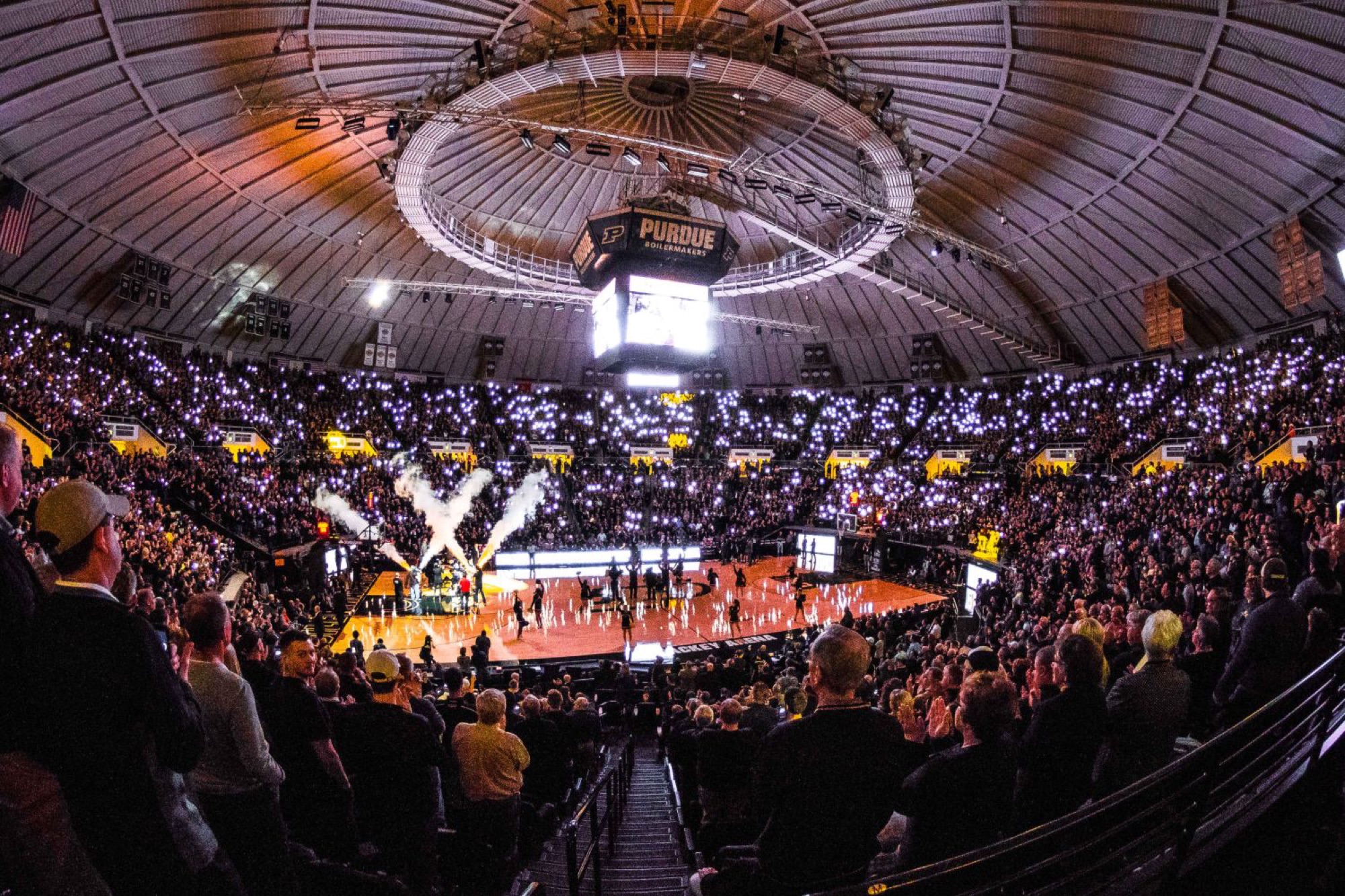 Mackey Arena on game night, student section lit up