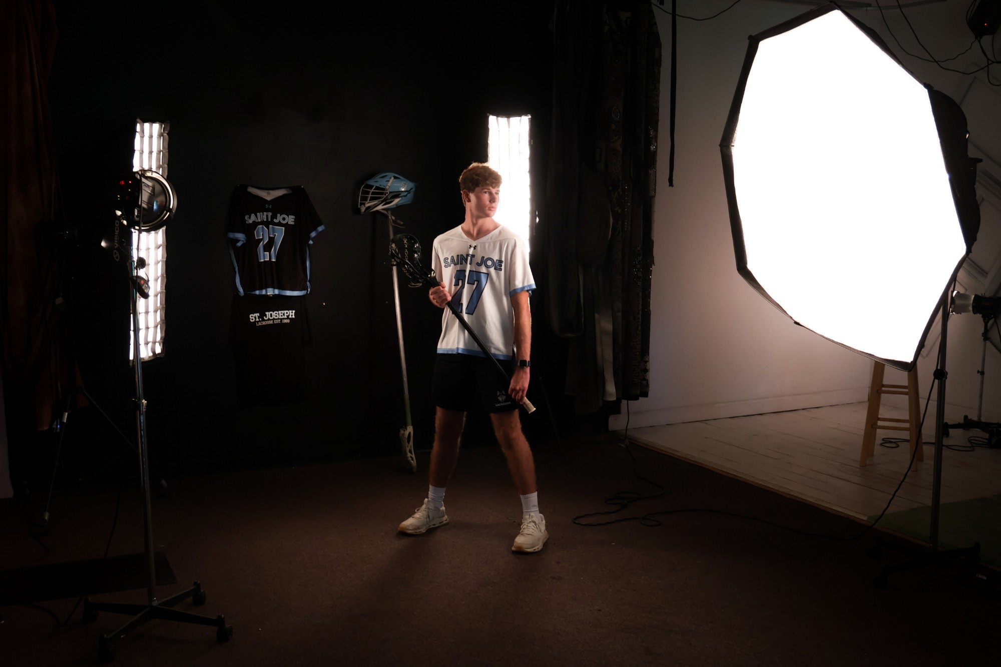 A lacrosse portrait session lit in the studio
